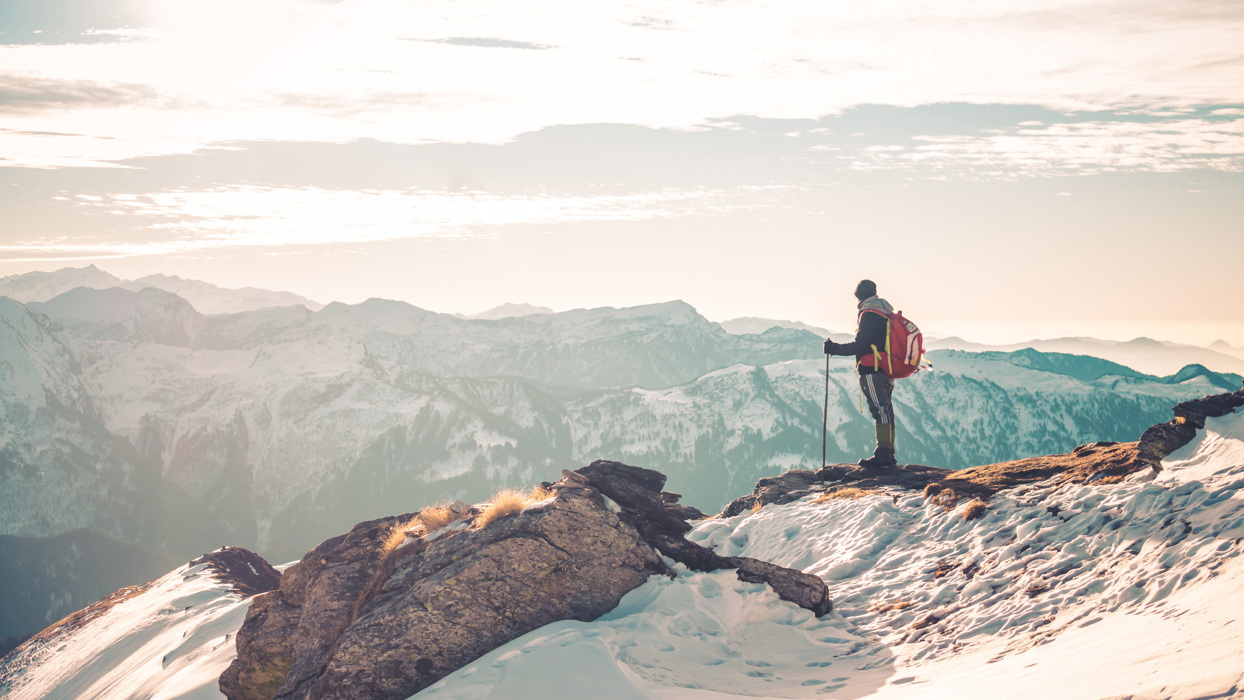 Man overlooking snowy mountains