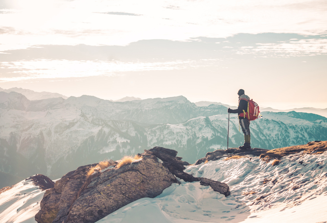 Man overlooking snowy mountains