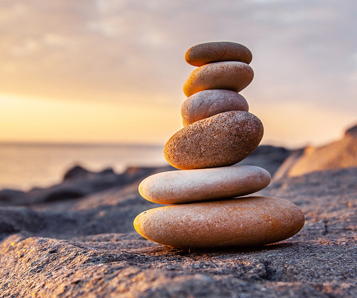 Stones balanced atop each other on a beach