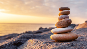 Stones balanced atop each other on a beach