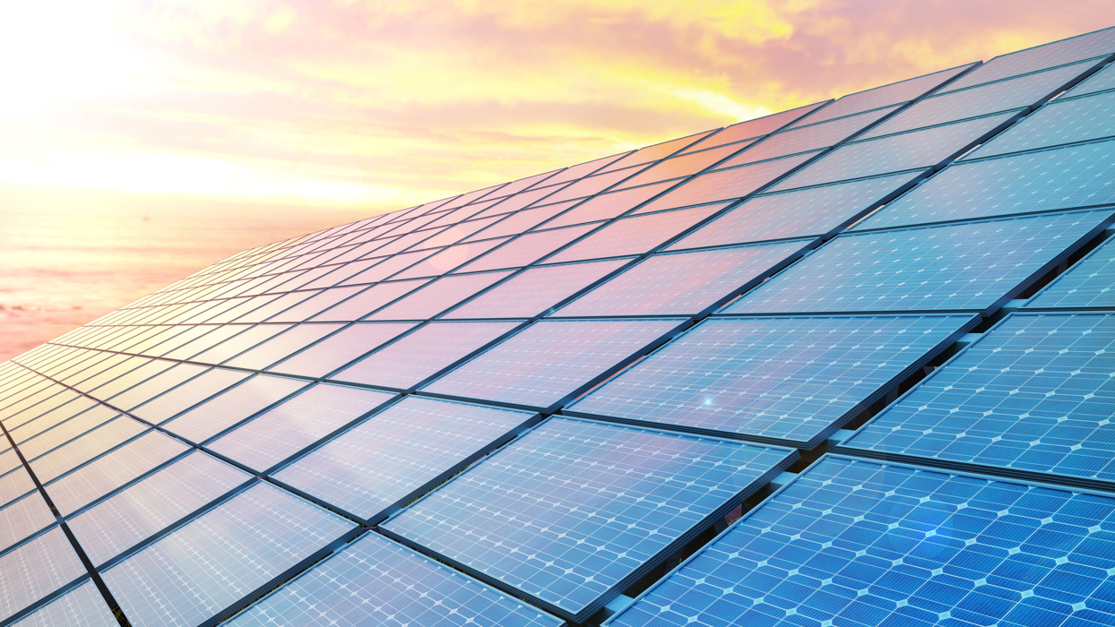 Solar Panels Against A Sunset Sky