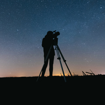 Person looking through a telescope