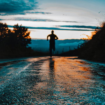 Man running down a road at night