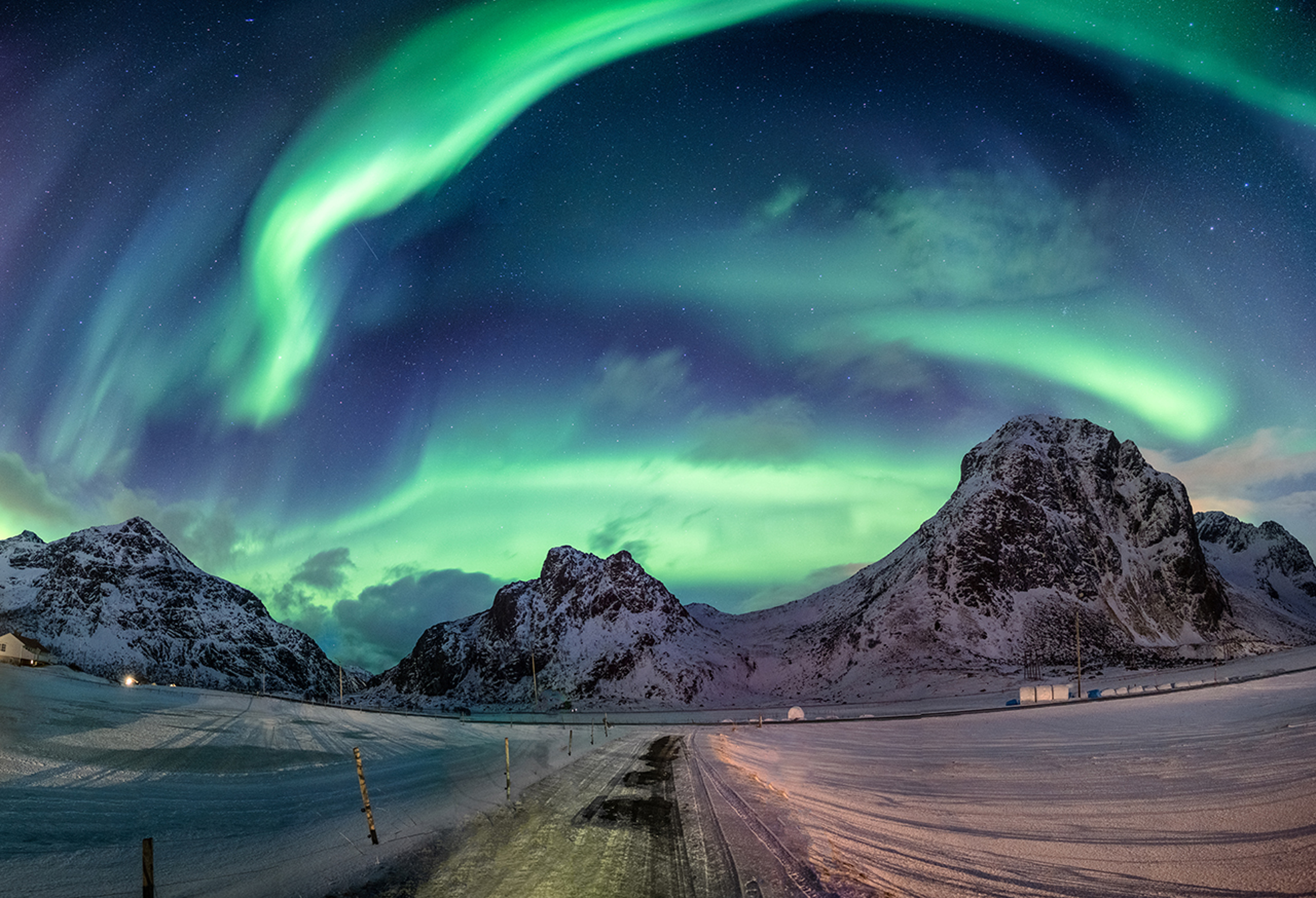 Norther lights over snowy hills