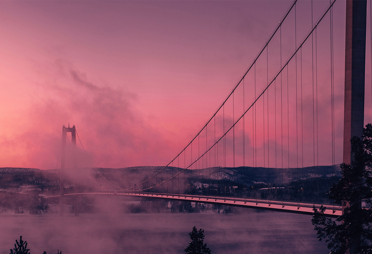 Misty bridge over a river