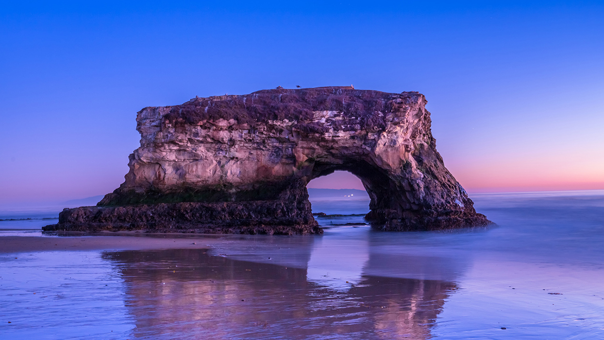 Rock Arch On Coastline