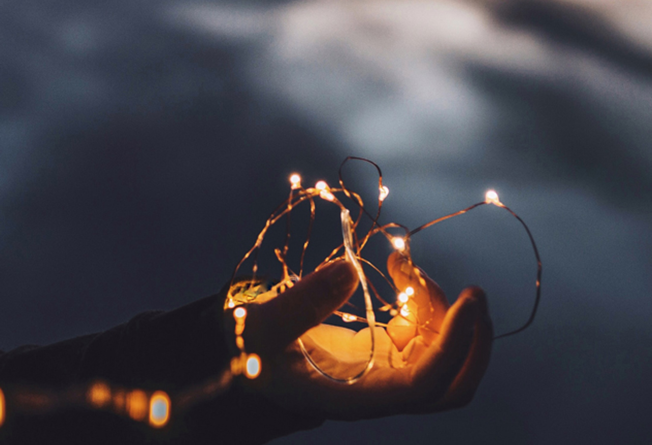 Child's hand holding fairy lights