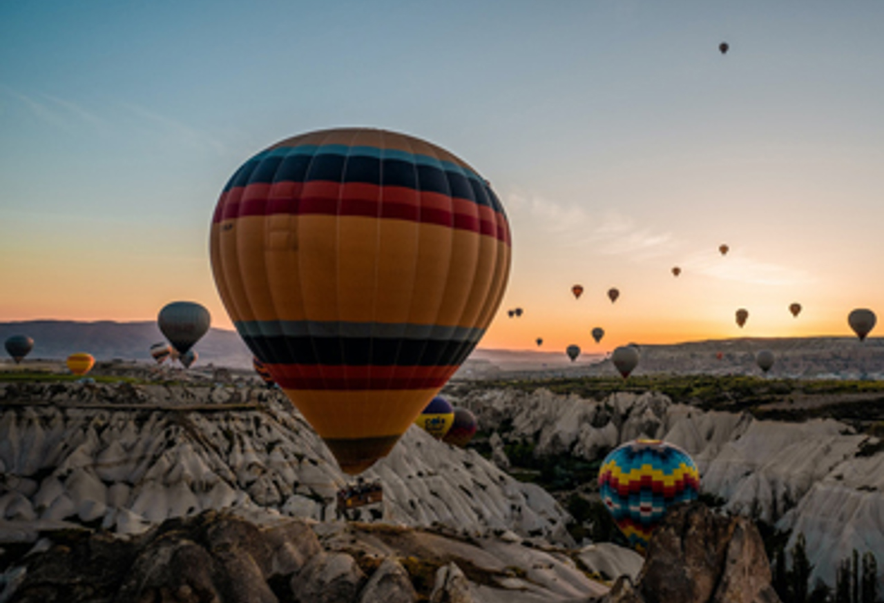 Hot air balloons over rocky valley