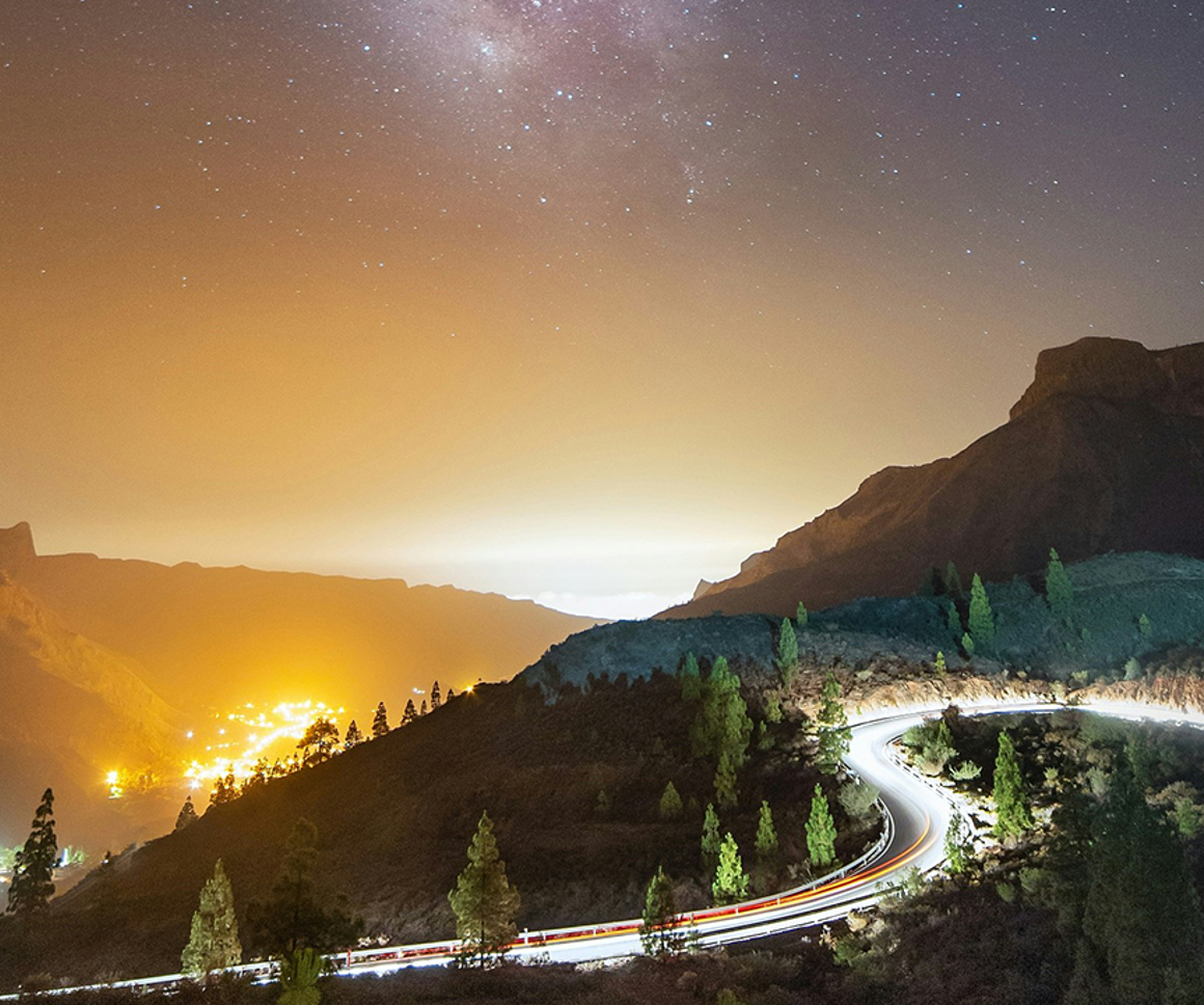 Highway Within Mountains At Night 