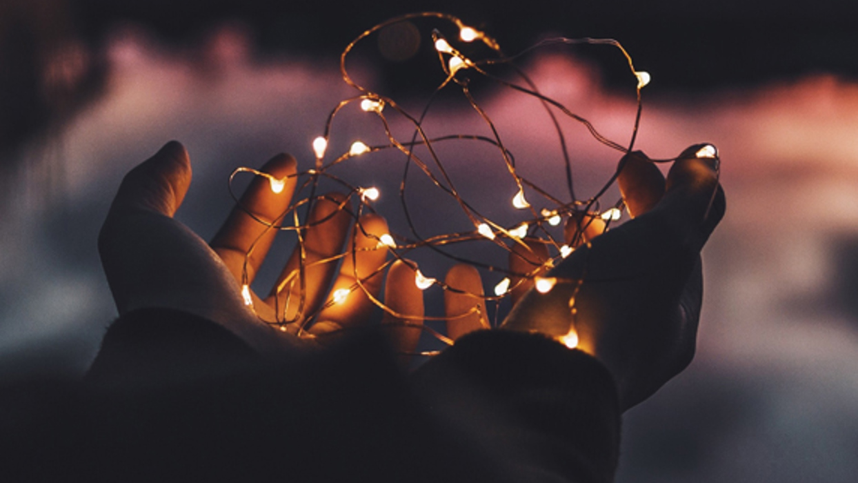 Child's hand holding fairy lights
