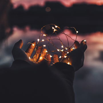 Child's hand holding fairy lights