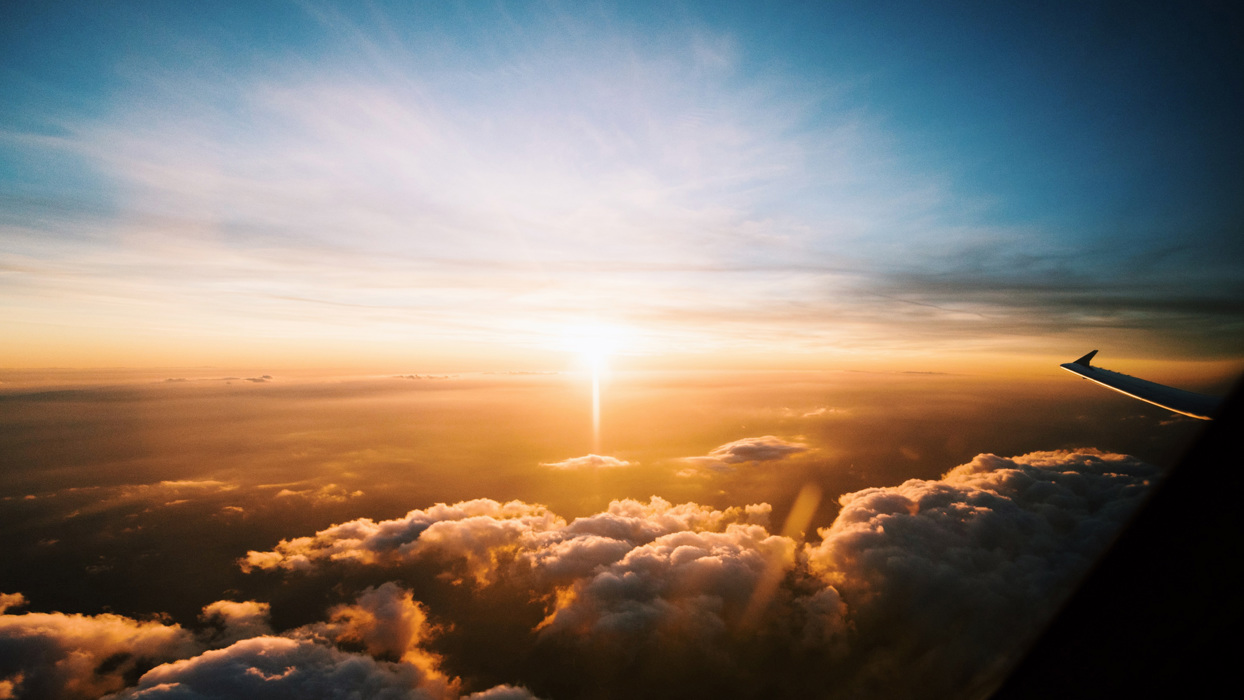 Plane wing above clouds