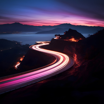 Long exposure lights of cars driving along a snaking road