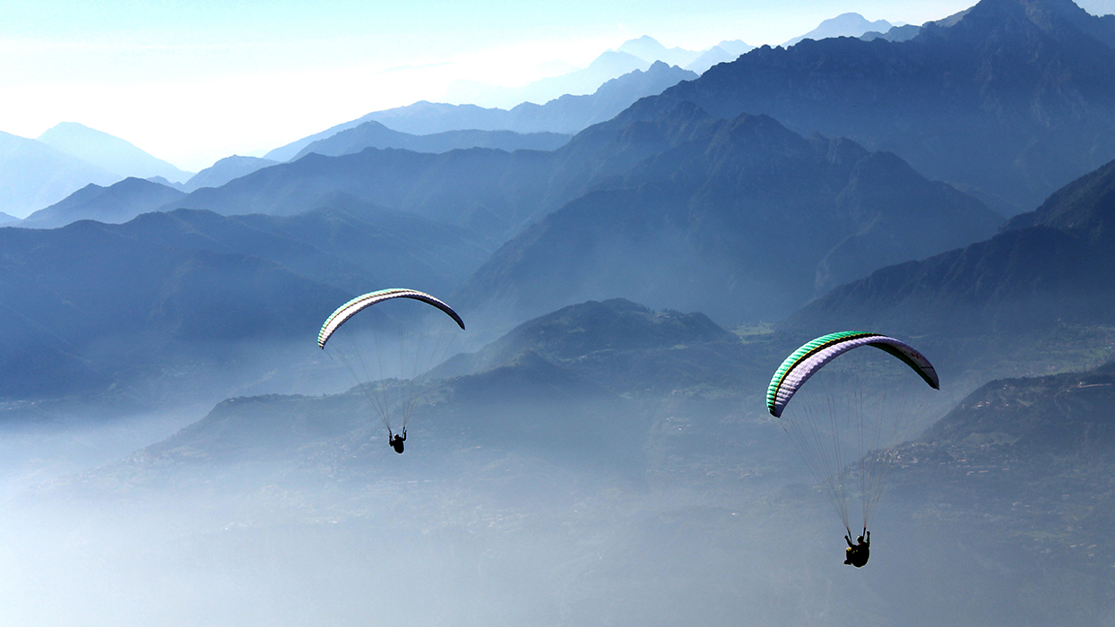 Hangliders over misty vally