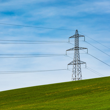 Electricity pylon in a green field