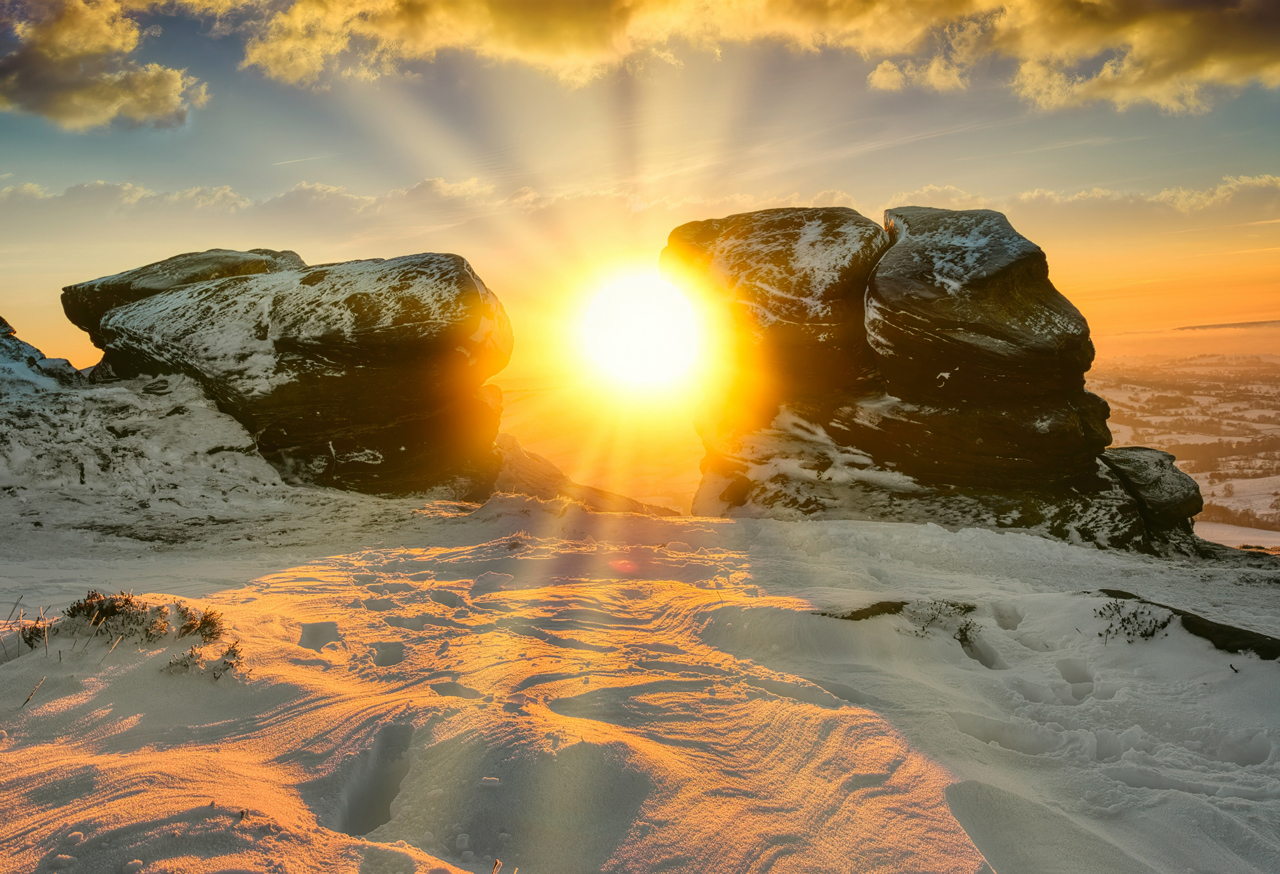 Sunset seen through rocky outcrop in snow