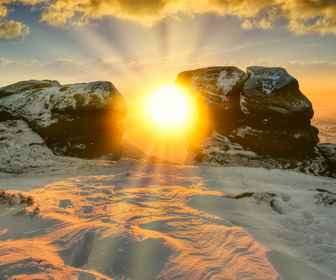 Sunset seen through rocky outcrop in snow