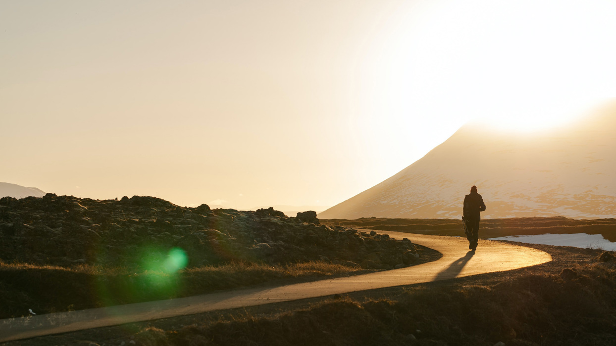 Man walking along winding road