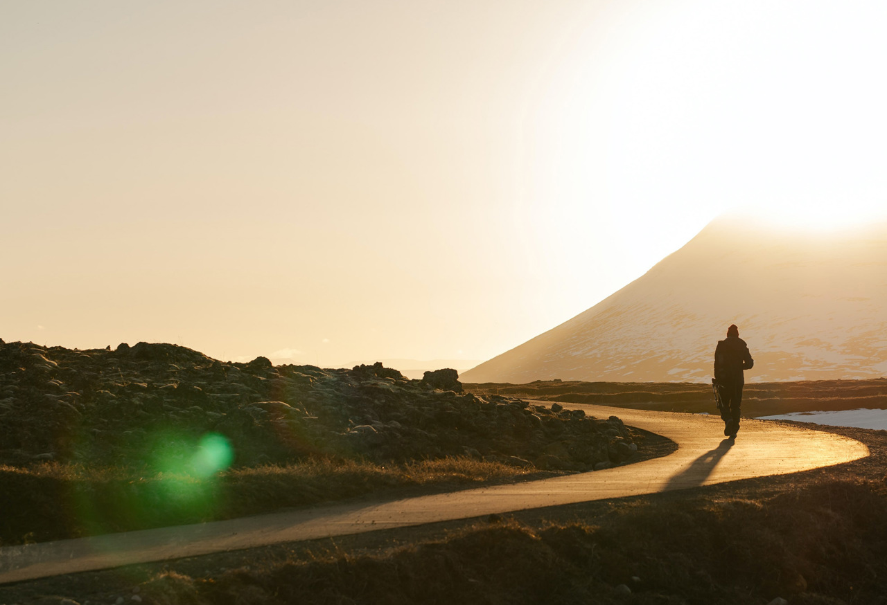 Man walking along winding road
